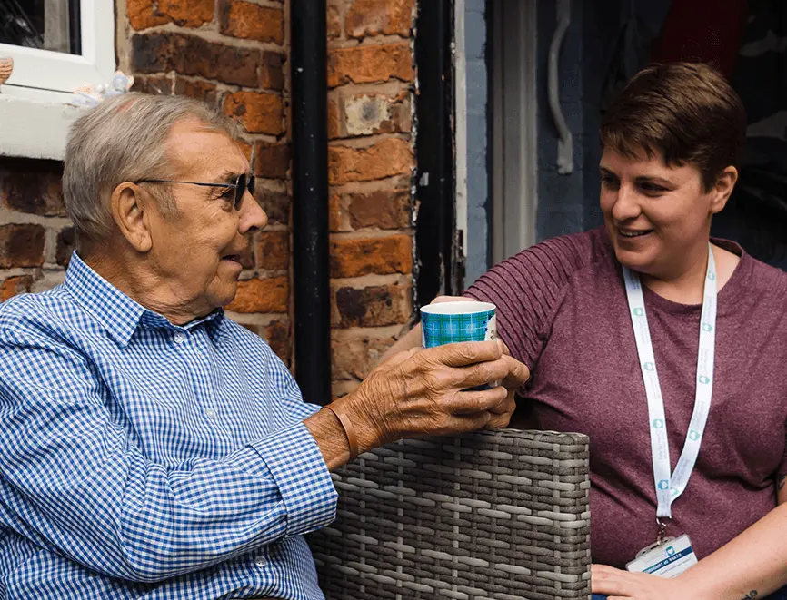 Homecare in Wilmslow — carer and client having a chat over coffee